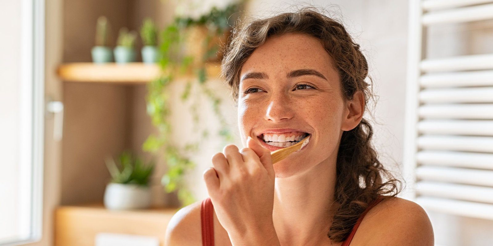 Woman brushing teeth with Total-Dent Complex oral care active